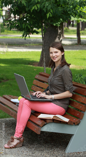 Young Woman with a Laptop in a Park