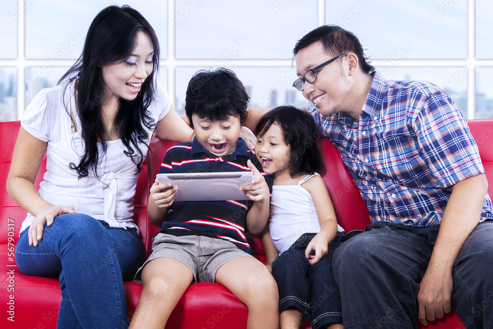 Excited family playing game at apartment Excited family playing game at apartment