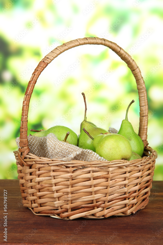 Pears in  wicker basket, on bright background