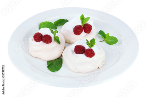 Tasty meringue cakes with berries, isolated on white