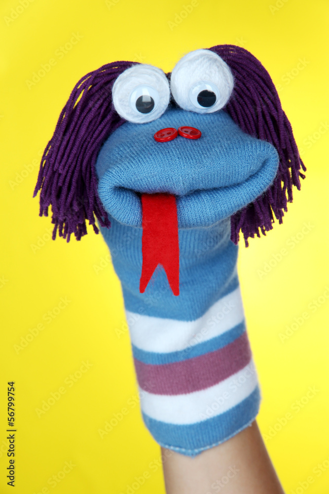 Fototapeta premium Cute sock puppet on yellow background