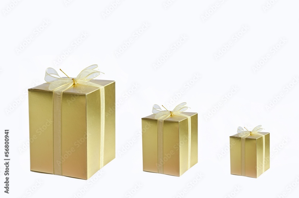 three golden gift box on wi\hite background three golden gift box on wi\hite background