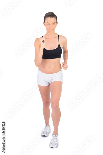 Serious woman in sportswear preparing for start