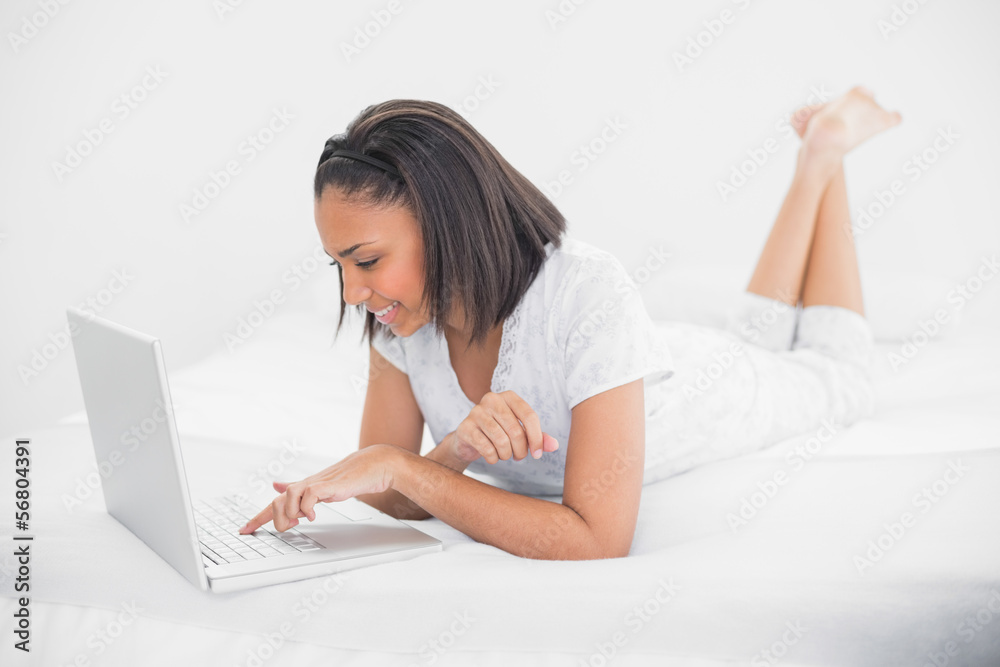 Content young dark haired model using a laptop Content young dark haired model using a laptop