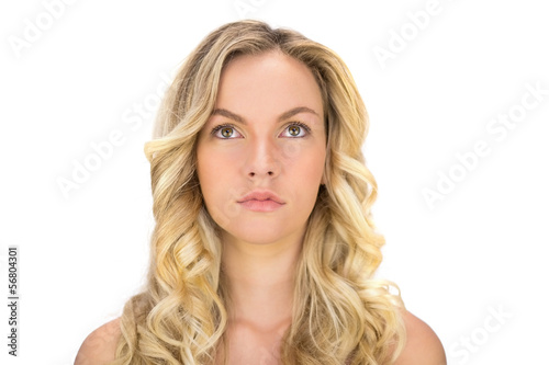Thoughtful curly haired blonde posing