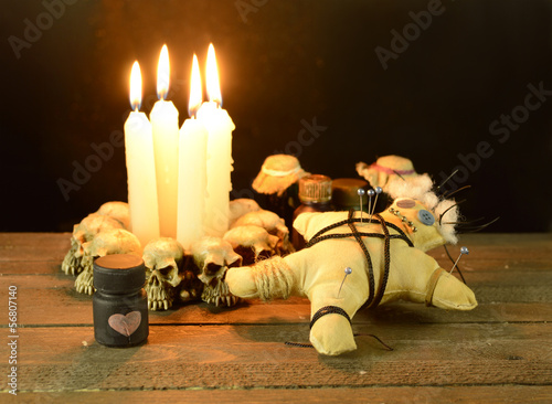 Pierced voodoo doll with love potion bottle photo