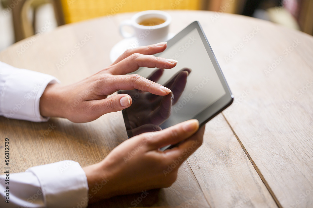Close up of hands woman using her tablet pc in restaurant, cafe Close up of hands woman using her tablet pc in restaurant, cafe