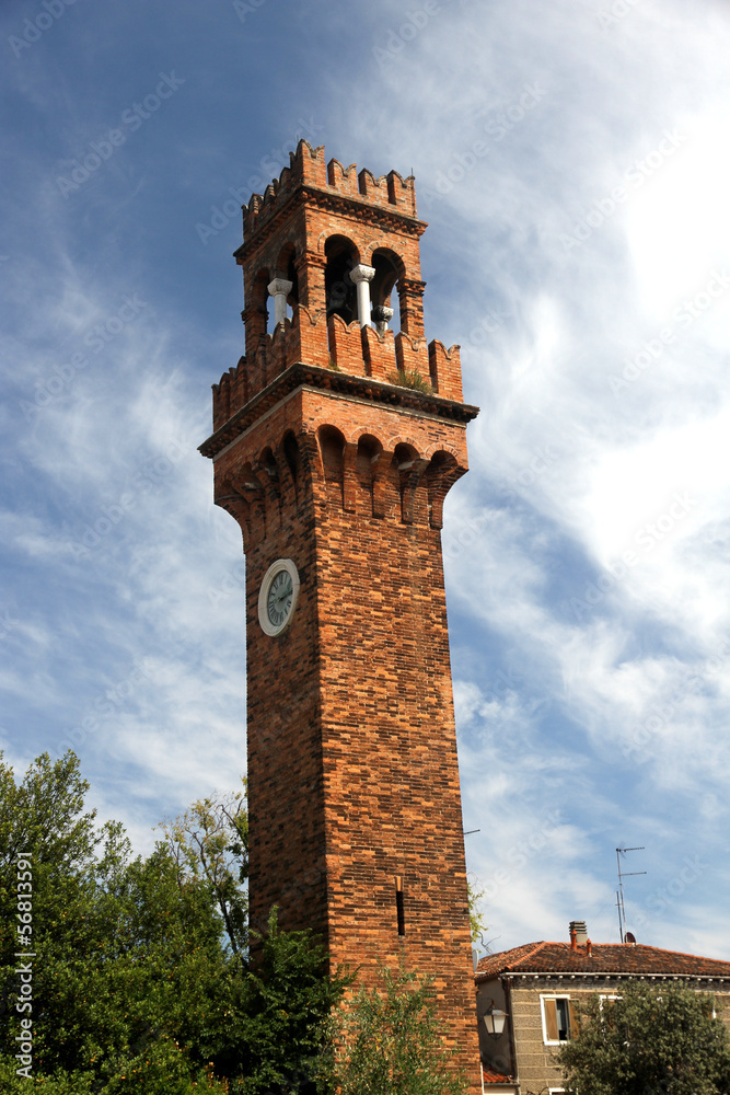 historic high Bell Tower with clock in the island of Murano