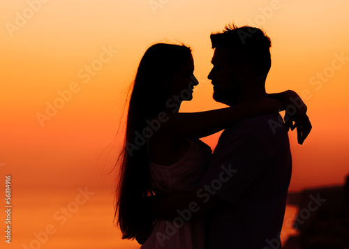 The image of two people in love at sunset