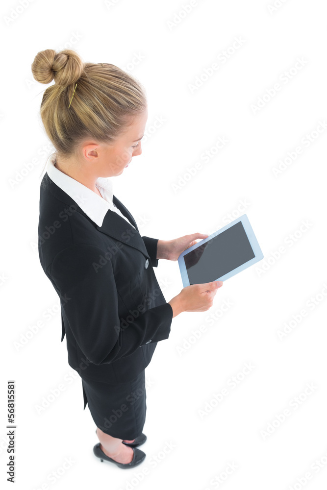 Profile view of attractive young businesswoman using her tablet Profile view of attractive young businesswoman using her tablet