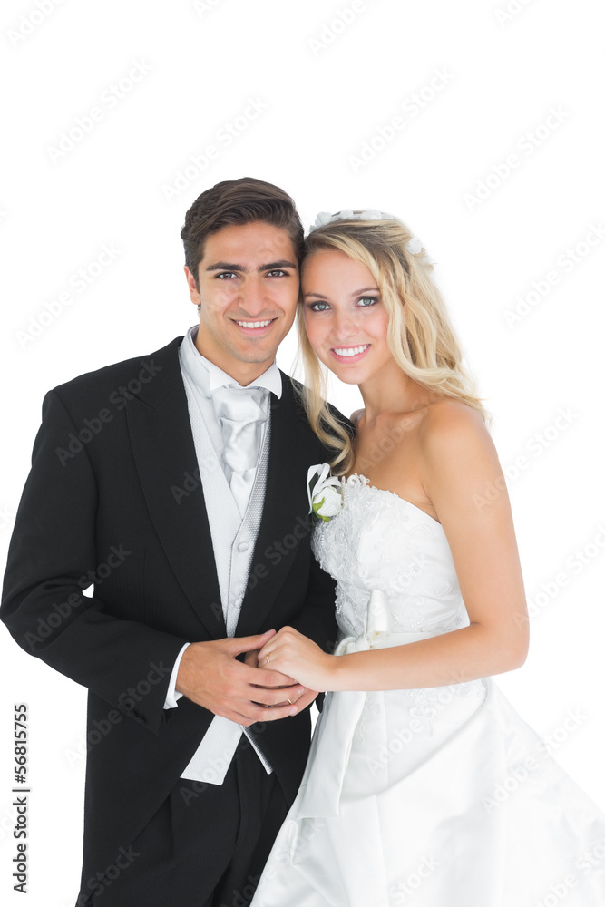 Cheerful cute married couple posing holding hands Cheerful cute married couple posing holding hands