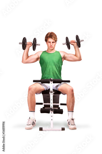 Young Man does physical exercises with dumbbells photo