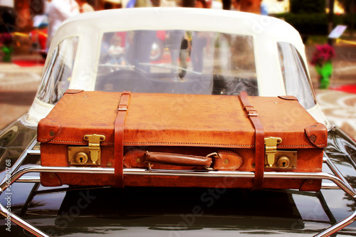 Vintage car with leather suitcase