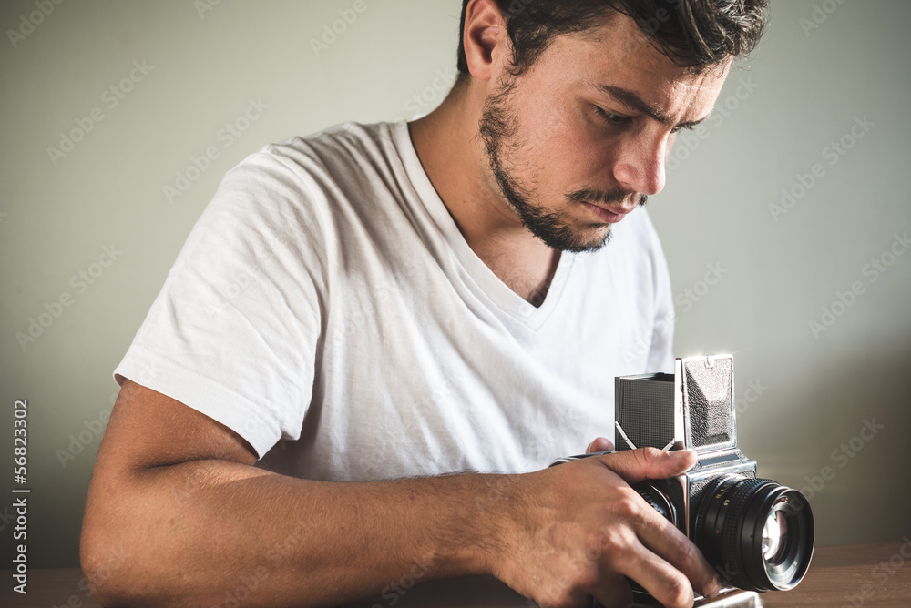 young stylish hipster man with old camera young stylish hipster man with old camera