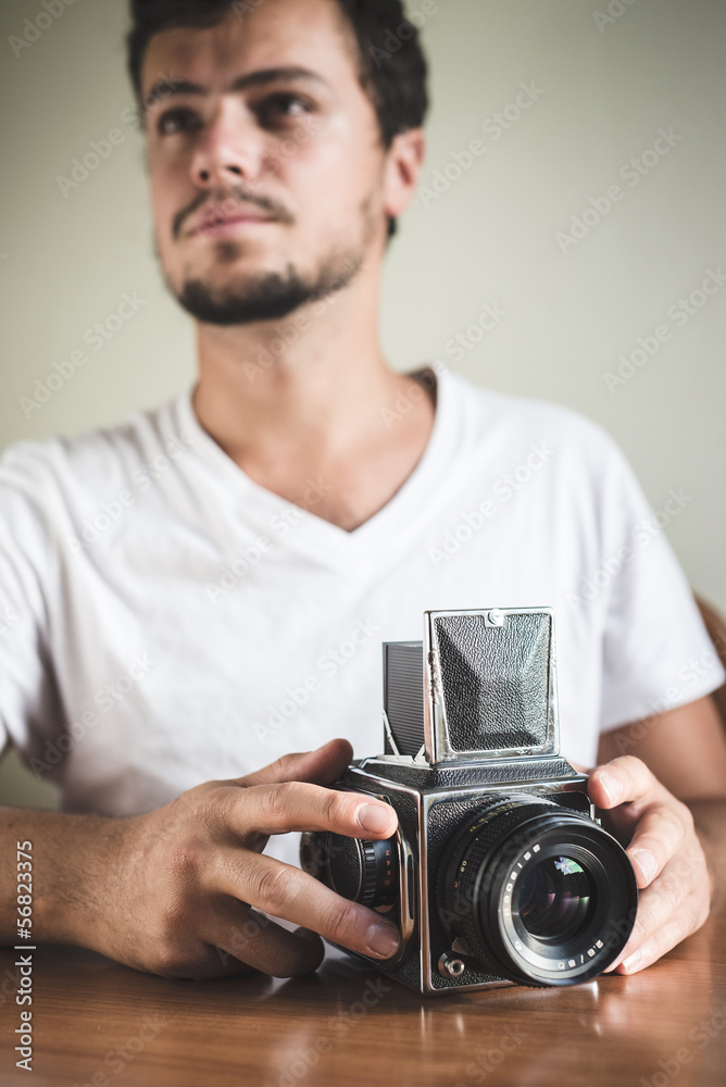 young stylish hipster man with old camera young stylish hipster man with old camera