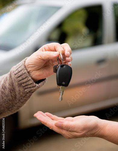 Hands and a car key
