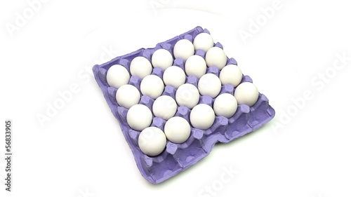 Tray of eggs on a white background loop photo