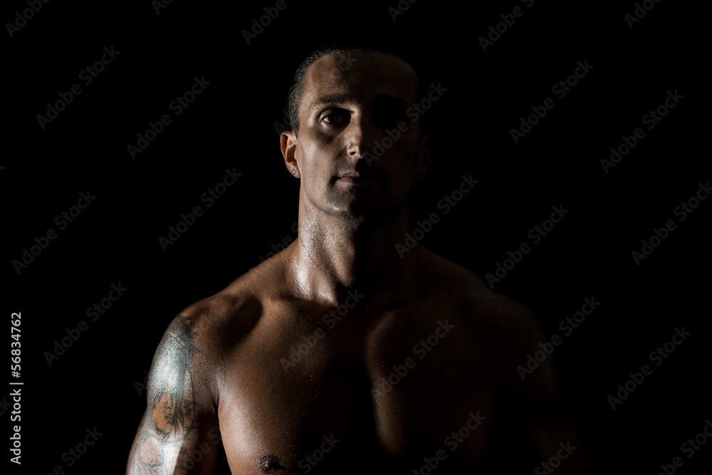 Muscular man in a black background