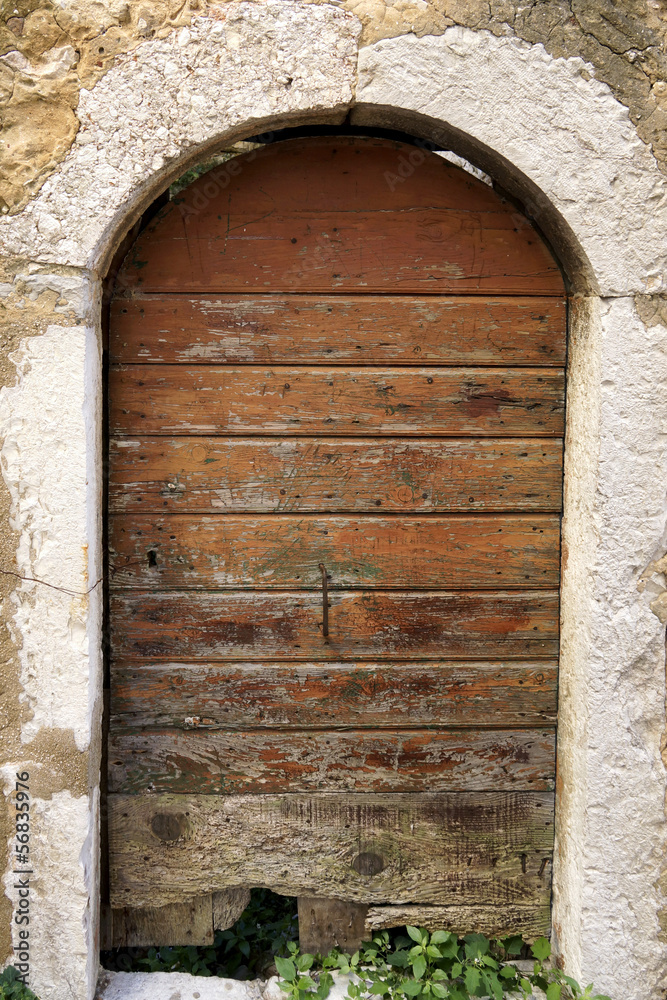 Old brown door with arch