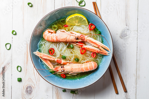 Closeup of Thai soup with scampi and noodles