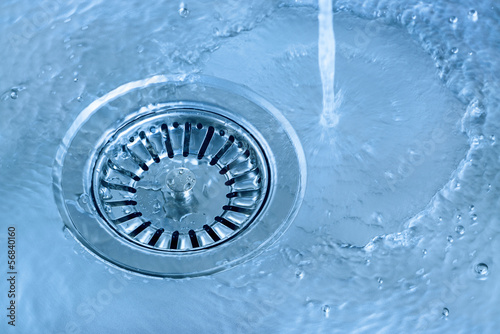 Kitchen sink in light blue, running water