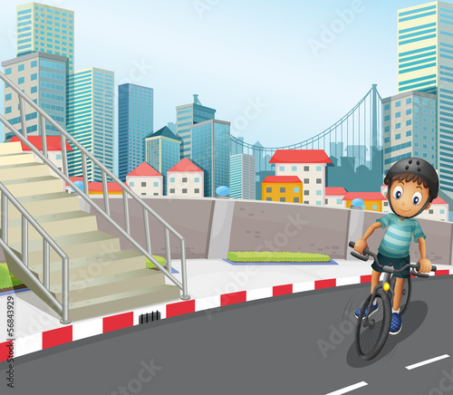 A boy biking at the road