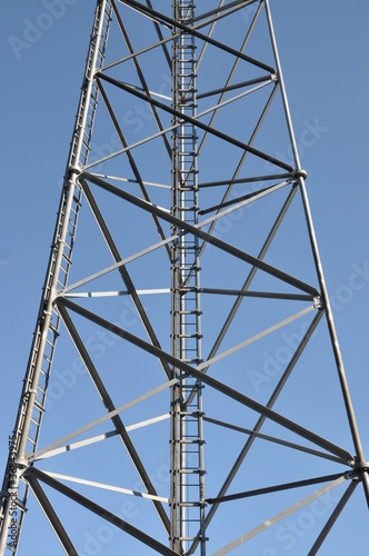 Construction of tower with ladder against blue sky
