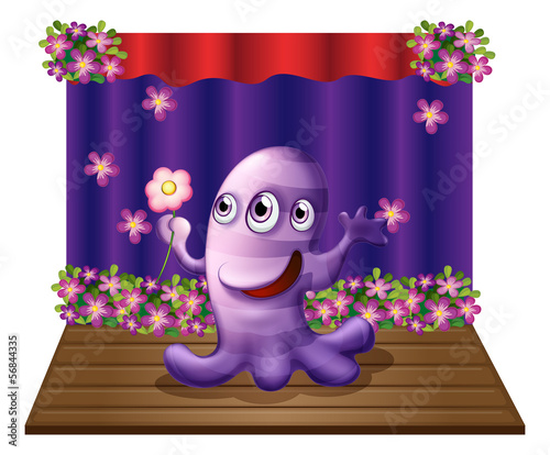 A three-eyed purple monster at the center of the stage