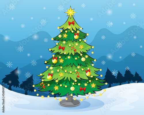 A christmas tree in the middle of the snowy land