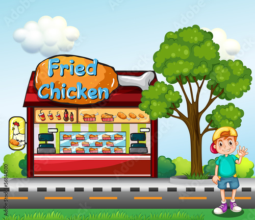 A young boy near the fried chicken store