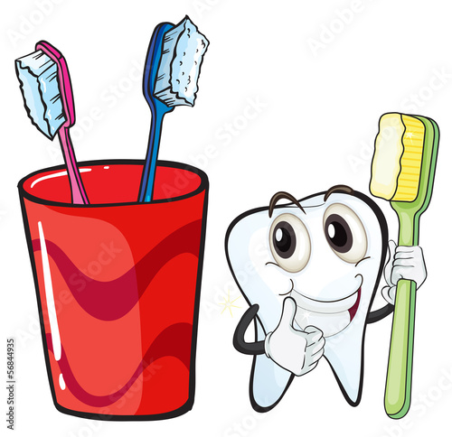 A tooth holding a toothbrush beside the glass