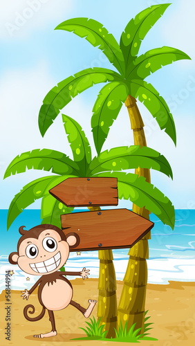 A beach with a smiling elephant near the wooden signboard