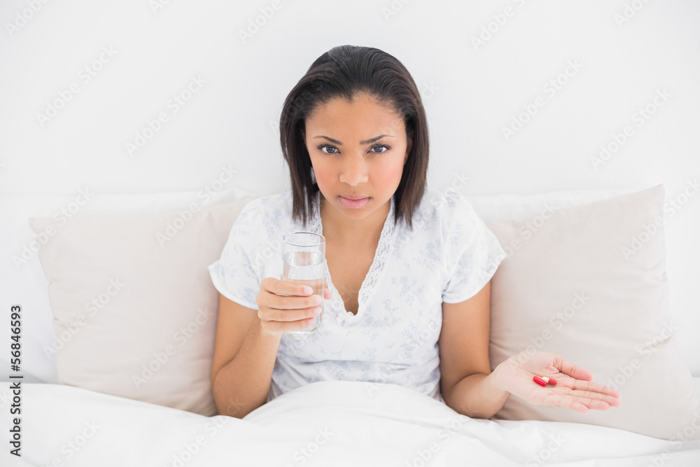 Stern young dark haired model taking medication Stern young dark haired model taking medication
