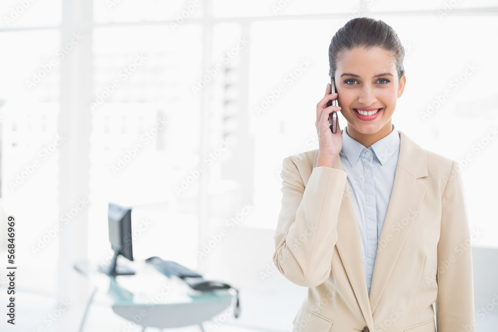 Happy smart brown haired businesswoman calling with her mobile p