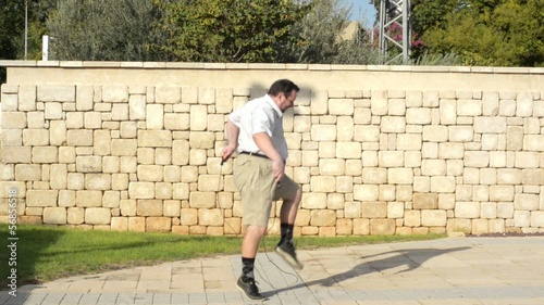 Fat man trying jump on the rope