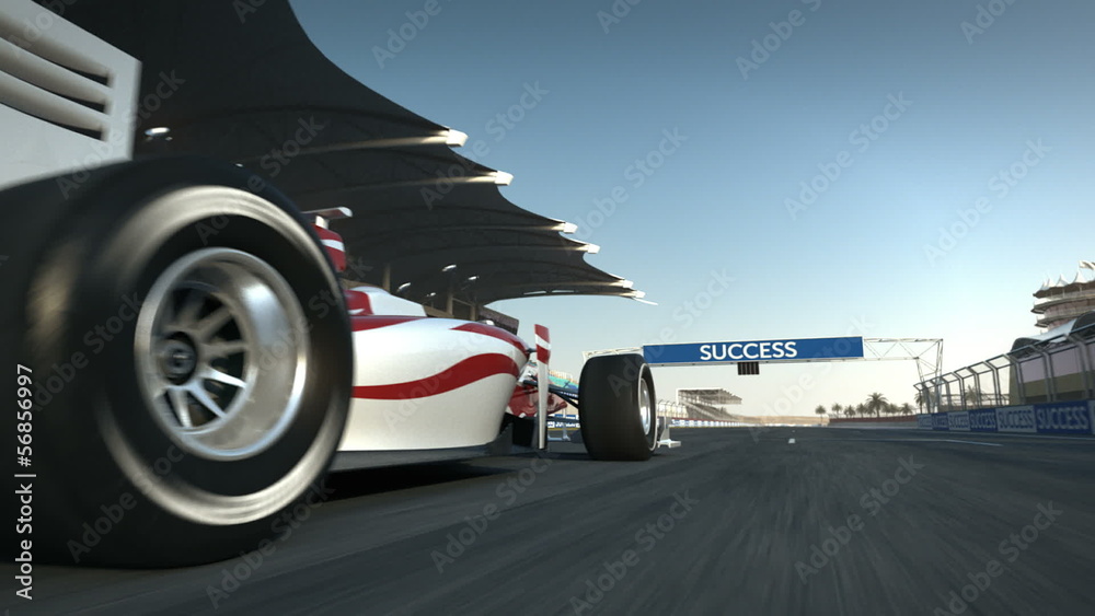 Formula One race car speeding along home stretch and past camera