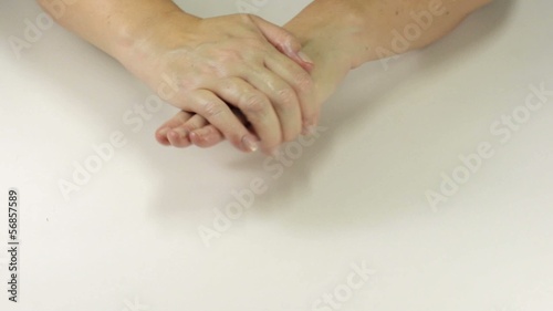 Housewife rubbing hand cream photo