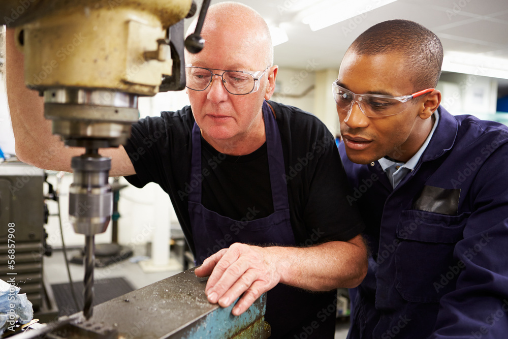 Engineer Teaching Apprentice To Use Milling Machine Engineer Teaching Apprentice To Use Milling Machine