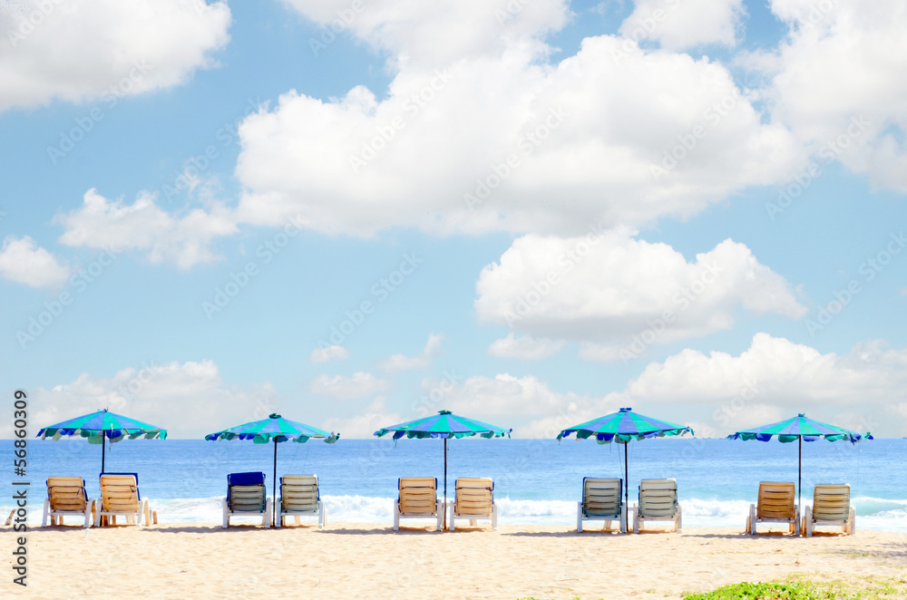 Beach chairs and with umbrella on the beach in cloudy day Beach chairs and with umbrella on the beach in cloudy day