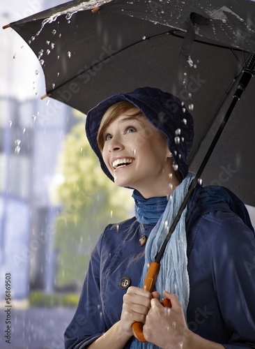 Happy young woman in the rain photo