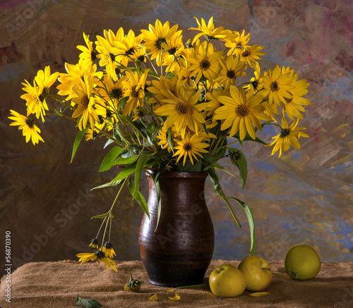 Bunch of bright yellow flowers (rudbeckia) in brown vase and app