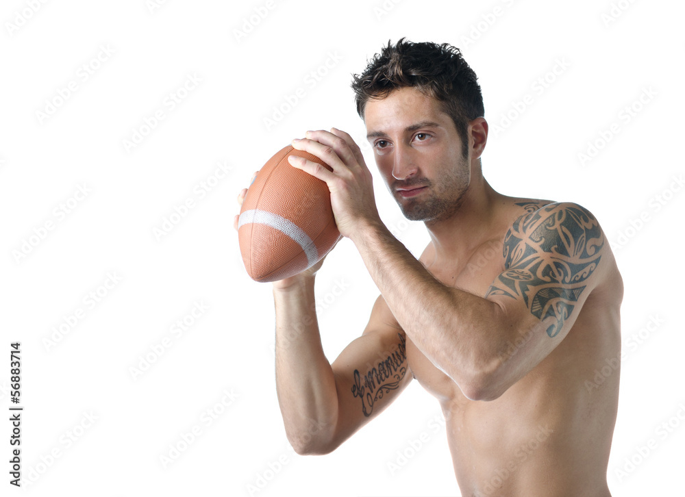 Handsome shirtless young man holding american football ball Handsome shirtless young man holding american football ball