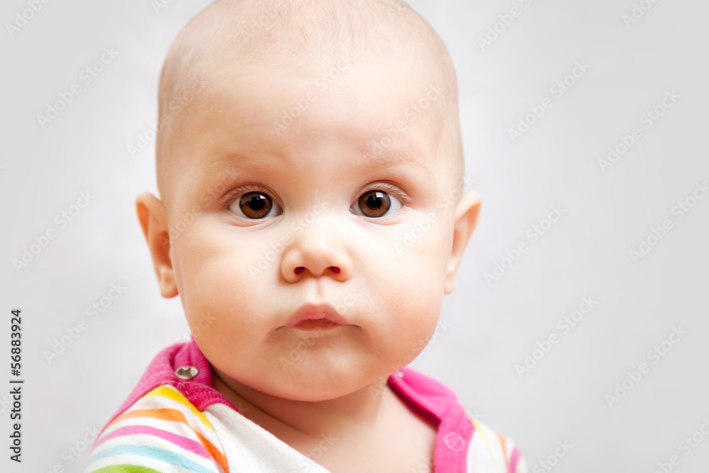 Little calm brown eyed Caucasian baby