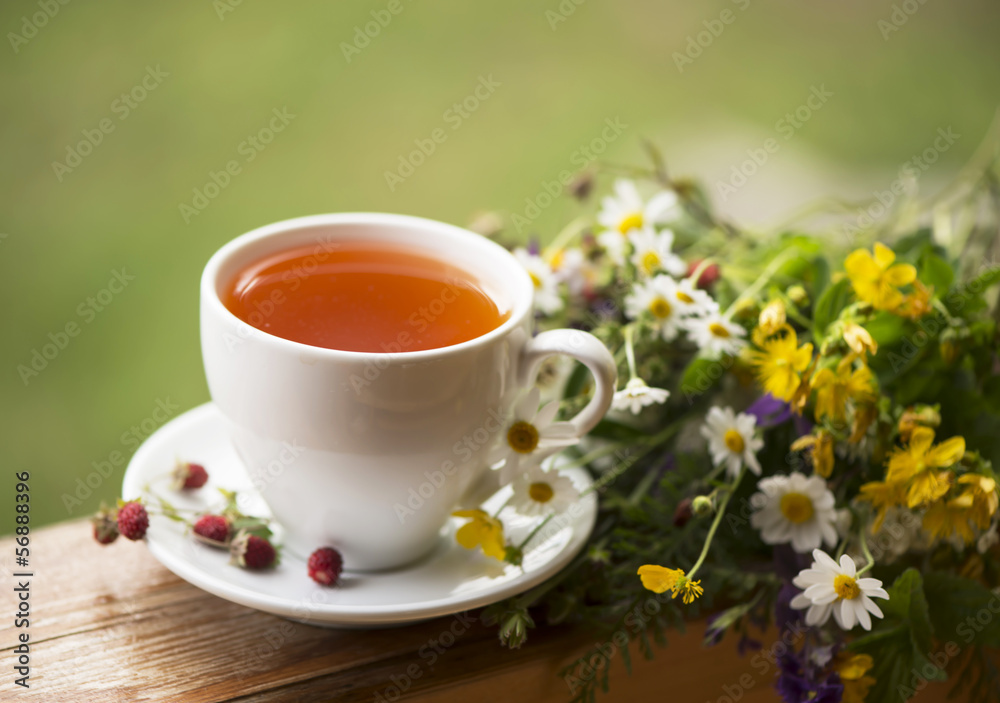 cup of aromatic tea, some berries of wild strawberry, bouquet of cup of aromatic tea, some berries of wild strawberry, bouquet of