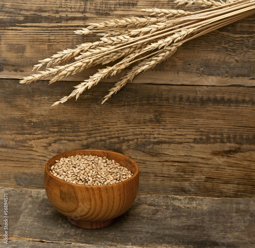 ears spike of wheat on wood texture background