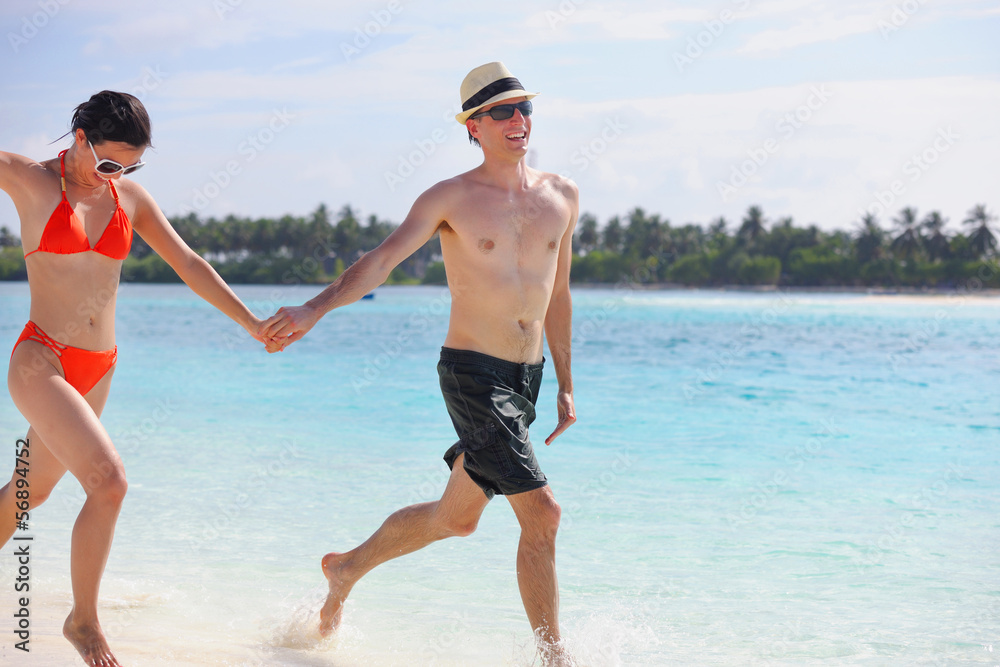 happy young couple have fun on beach happy young couple have fun on beach