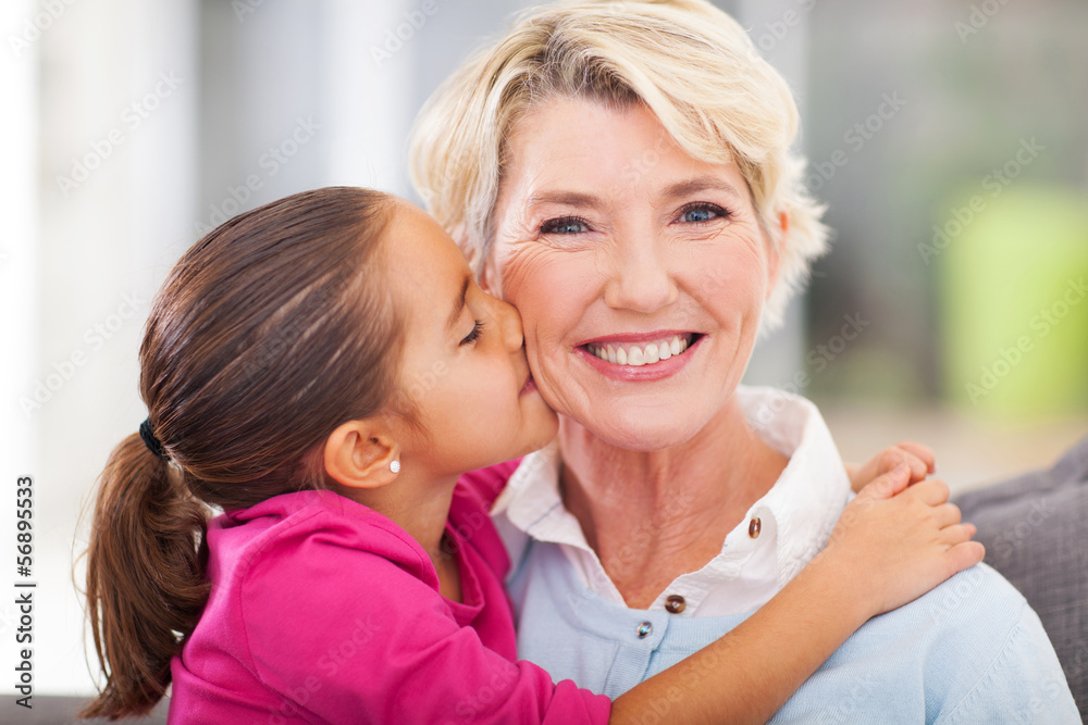 cute granddaughter kissing her grandmother cute granddaughter kissing her grandmother