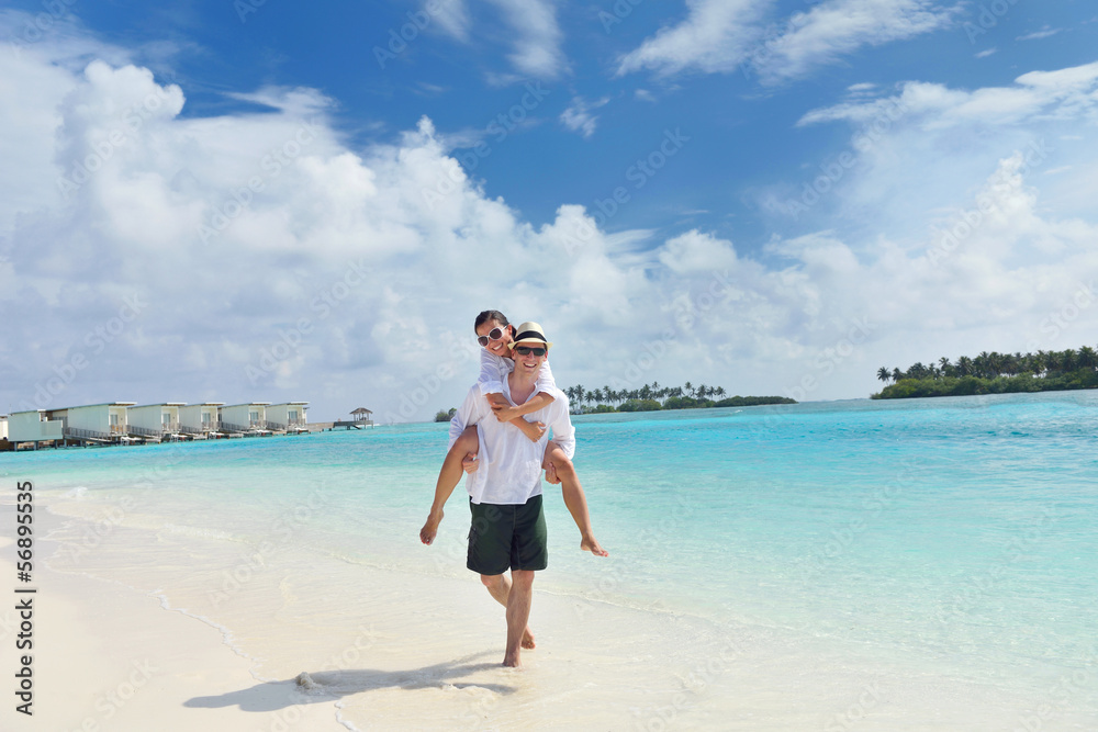 happy young couple have fun on beach