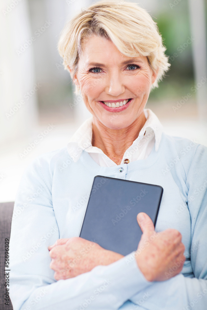 senior woman holding tablet computer senior woman holding tablet computer