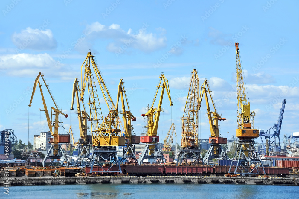 Port cargo crane over blue sky background